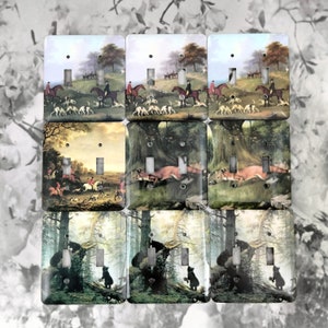 May include: Nine light switch covers with different nature scenes. The top row features a hunting scene with riders on horseback and hounds. The middle row features a fox running through a forest. The bottom row features a black bear and cub in a forest setting.
