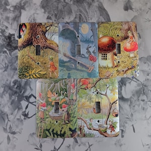 May include: A collection of five light switch covers featuring whimsical illustrations. Each cover showcases a different fairy tale scene with vibrant colors, including gnomes, fairies, mushrooms, and woodland creatures. The covers have a glossy finish and are designed to fit standard light switches.