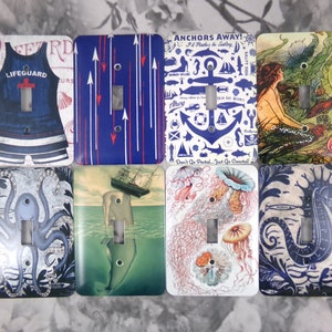 May include: Set of ten decorative light switch covers featuring nautical and ocean-themed designs. The designs include a lifeguard swimsuit, arrows, an anchor, a mermaid, an octopus, a ship, jellyfish, and a seahorse. The switch covers are white with various colored designs.