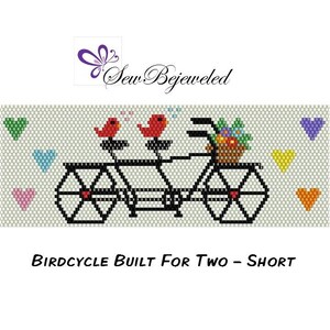 May include: A black and white beaded design of a bicycle with two red birds perched on the handlebars. The bicycle has a basket with flowers and hearts are scattered around the design. The text "Birdcycle Built For Two - Short" is below the design.