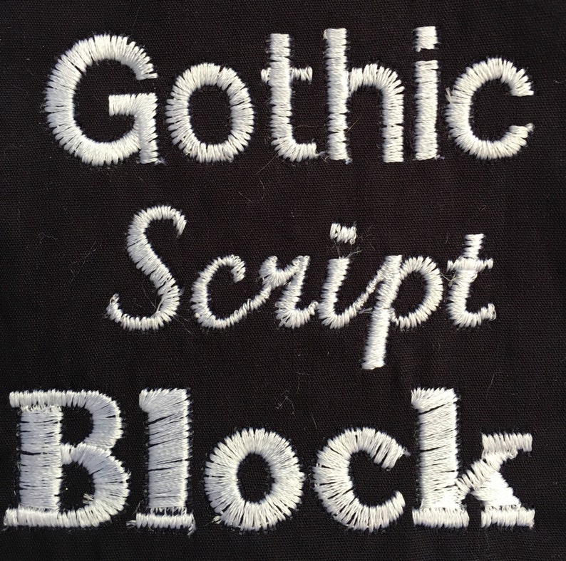 May include: Close-up of white embroidered text on black fabric. The text reads "Gothic Script Block".