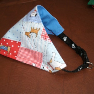 May include: A blue, red and white patterned dog bandana with a black adjustable strap and a silver buckle. The bandana features a variety of dog illustrations.