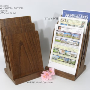 May include: Dark walnut wood magazine rack with four slots for holding magazines or brochures. The rack is 6.5 inches wide by 5.87 inches deep by 10.75 inches high. The rack has a 1.5 inch reveal. The rack is made by OakHill Wood Creations.