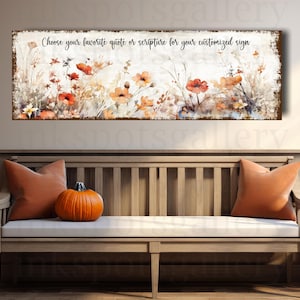May include: A long rectangular sign with a floral design in shades of orange, red, and yellow. The sign has the text "Choose your favorite quote or scripture for your customized sign". The sign is displayed above a wooden bench with orange pillows and a pumpkin.