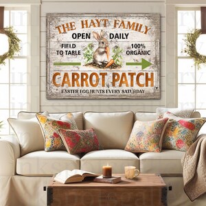 May include: A rustic wooden sign with the text "THE HAYT FAMILY CARROT PATCH" and a rabbit holding a carrot. The sign also includes the phrases "Open Daily", "Field to Table", "100% Organic", and "Faster Egg Hunts Every Saturday".