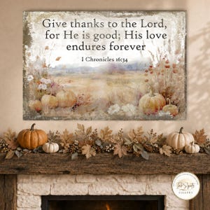 May include: A rectangular wall art print featuring a watercolor-style landscape with pumpkins and wildflowers. The text reads: Give thanks to the Lord, for He is good; His love endures forever. 1 Chronicles 16:34. The color palette includes muted oranges, browns, and creams.