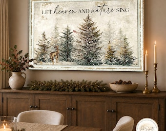 May include: A rectangular wall art print featuring a winter forest scene with evergreen trees, a deer, and a cardinal. The text "LET heaven AND nature SING" is printed in black script and serif font across the top of the distressed white background.