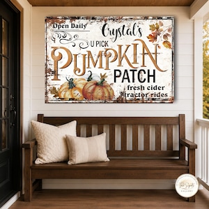 May include: A rectangular wall sign with a distressed white background featuring the text "Open Daily", "Crystal's U PICK PUMPKIN PATCH", "fresh cider", and "tractor rides". The design includes illustrations of orange pumpkins and autumn leaves.