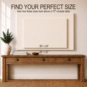 May include: A rectangular wooden console table with three drawers, positioned below two stacked rectangular canvas frames. The text reads: FIND YOUR PERFECT SIZE, See how these sizes look above a 72" console table, 36" x 24", and 48" x 32".