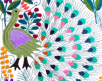 Handwoven and hand-embroidered peacock wall tapestry or table runner in white and multi-color. Fairtrade made by Maya women's cooperative