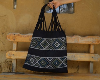Black hammock tote back with diamond brocade designs in cool colors, handmade in Mexico by women's weaving cooperative