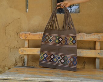 Brown hammock tote back with diamond brocade designs in cool colors, handmade in Mexico by women's weaving cooperative