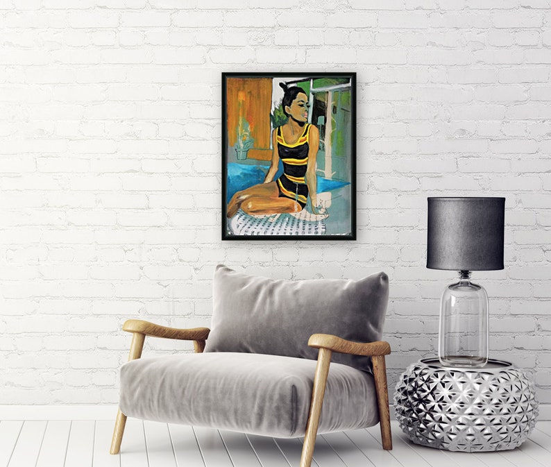 May include: A painting of a woman in a yellow and black swimsuit sitting by a pool. She is holding a glass of wine and looking out the window. The painting is framed in black.