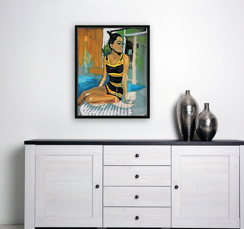 May include: A painting of a woman in a black and yellow swimsuit sitting on a patterned towel by a pool. The woman has dark hair and is looking to the right. The background is a blurred image of a building and trees.