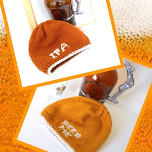 May include: Two knitted beanies, one brown and one mustard yellow, with white trim. The brown beanie has "IPA" stitched on it, and the yellow one says "BEER ME". A brown beer bottle with a silver handle is in the background.