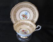 Paragon Double Warrant Cup and Saucer Gold Filigree Floral Center