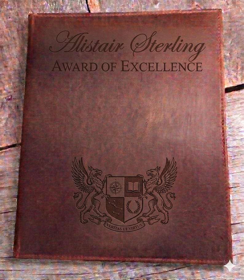 May include: A brown leather award certificate featuring the name "Alistair Sterling" and "AWARD OF EXCELLENCE". The certificate has an engraved crest with two griffins, a compass, a book, and the motto "Veritas et Virtus".