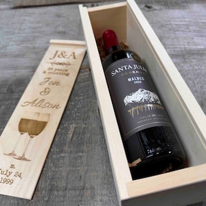 May include: A wooden wine box with a personalised engraved label. The label reads "J&A 25 years & counting Jon & Alison m. July 24, 1999". The box contains a bottle of Santa Julia Reserva Malbec wine.