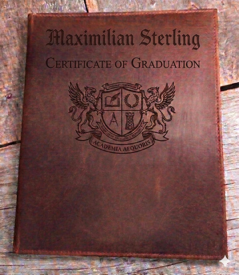 May include: A brown leather certificate holder. The cover is embossed with the name "Maximilian Sterling" and "CERTIFICATE OF GRADUATION". A crest featuring griffins and the words "ACADEMIA AEQUORIS" is also visible.