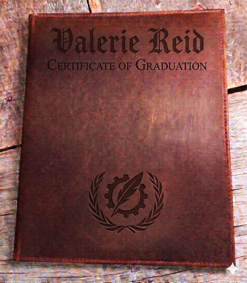 May include: A brown leather certificate holder with the name "Valerie Reid" and "Certificate of Graduation" engraved on the front. A gear and feather emblem is also engraved. The holder is rectangular.