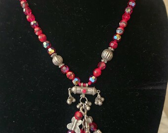 Beautiful and exotic red crystal beaded necklace with tribal sterling silver pendant/charms and sterling silver clasp and extender chain.
