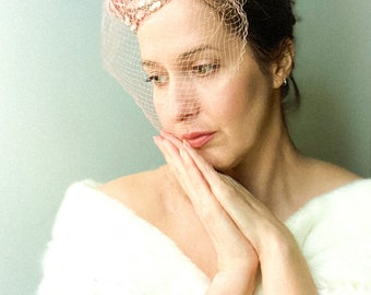 Pink sequin pill box hat with partial veil and side combs. 1950-60’s hat.