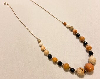 1990’s stone bead necklace in peace and black tones. Unique stone beads layered on a chain.
