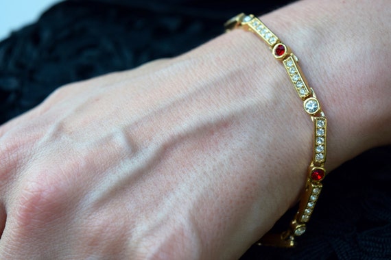 Rhinestone bracelet with red accents gold tone li… - image 1