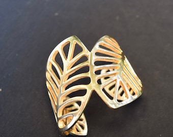Open work gold tone bracelet in leaf motif. Gold lead cuff bracelet.