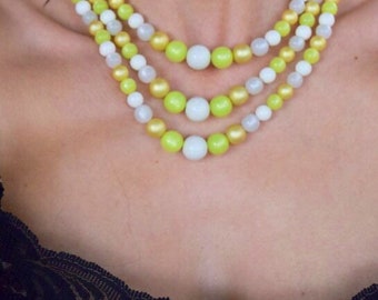 Moonglow necklace in yellow ,green, and white beads. Midcentury lucite beaded necklace. Multi color three stand necklace.