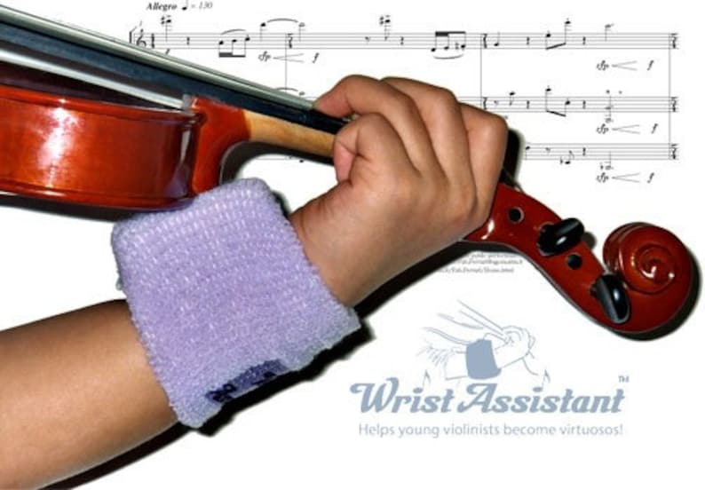 May include: A young violinist wearing a purple wristband practices playing a violin. The violin is brown with a black fingerboard and a scroll. The image includes sheet music with the word "Allegro" and musical notes. The text "Wrist Assistant" is visible in the lower right corner of the image. The text "Helps young violinists become virtuosos!" is below the "Wrist Assistant" text.