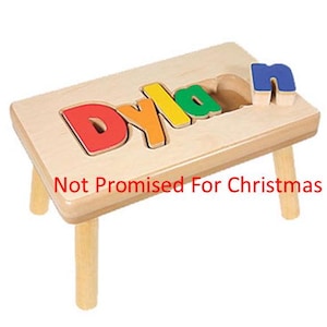 May include: A wooden stool with the name "Dylan" spelled out in colorful puzzle pieces. The letters are removable and can be used for learning.