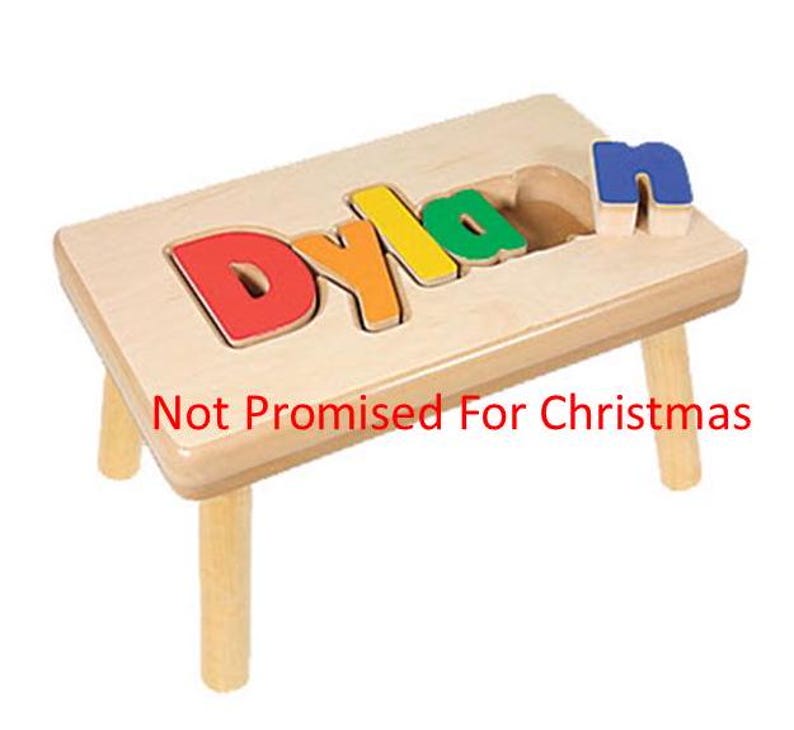 May include: A wooden stool with the name "Dylan" spelled out in colorful puzzle pieces. The letters are removable and can be used for learning.