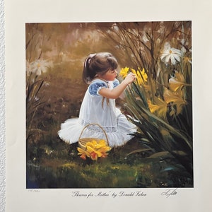 May include: A framed print titled "Flowers for Mother" by Donald Zolan. The artwork depicts a young girl in a white dress picking yellow daffodils. A woven basket filled with flowers sits nearby. The background features a garden setting with other flowers.
