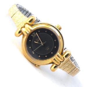 Ladys Timex Indiglo wrist watch: Vintage in very good running condition, gold tone with stretch band