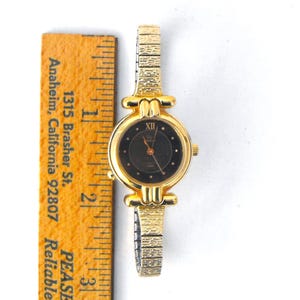 The watch case measures 24.5mm diameter, not including crown; the band is 8mm wide at the lugs, tapering to 6mm at the center back; the unstretched inside circumference of the watch is approximately 6 inches.  Your vintage Timex arrives carefully packaged for a safe journey to you!