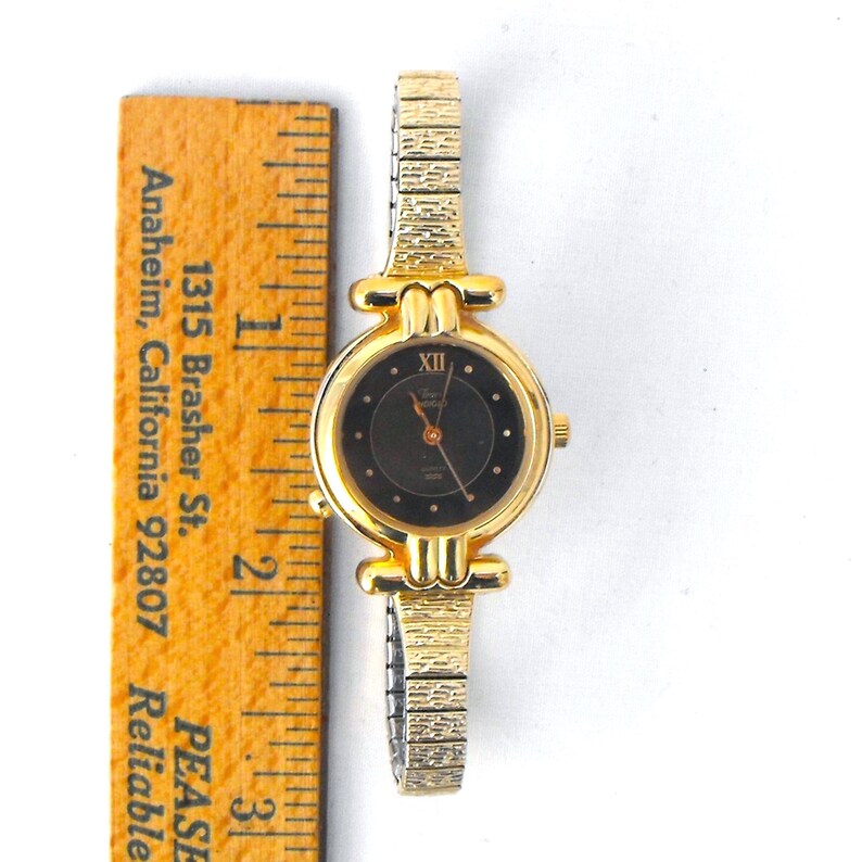 The watch case measures 24.5mm diameter, not including crown; the band is 8mm wide at the lugs, tapering to 6mm at the center back; the unstretched inside circumference of the watch is approximately 6 inches.  Your vintage Timex arrives carefully packaged for a safe journey to you!