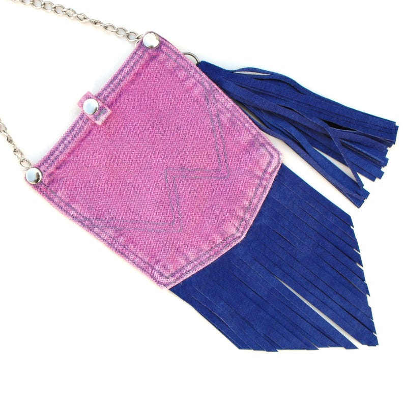 Constructed from very cool upcycled pink denim pockets, with blue suede details and snap closure.