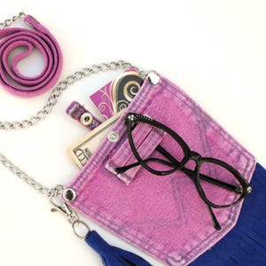 Reclaimed belt loops have been added to the handmade mini-purse for attitude (and a little extra function!)  Seen here with a pair of glasses hooked onto the decorativ belt loop.
