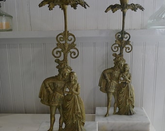 Pair of brass figural candleholders on marble base