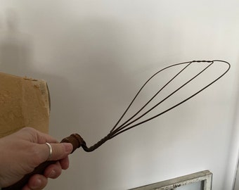 Teardrop shaped wire rug beater with wood handle