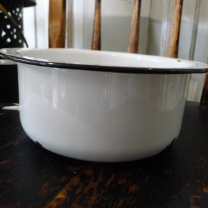 White enamelware handled bowl