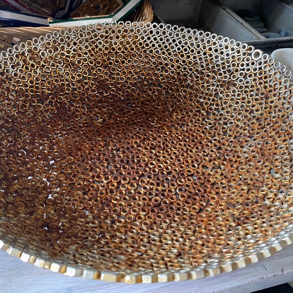Large metal bowl crafted from welded hardware nuts
