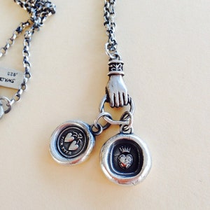 Antique wax letter seal necklace, with heart charms, on a long sterling rolo chain, with a hand holder.