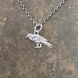 Itsy bitsy tiny raven.  Tiny crow add on to enhance your amulets. Sterling silver bird charm.