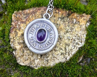 Nil Desperandum, Do not despair, sterling silver pendant with amethyst cabochon.