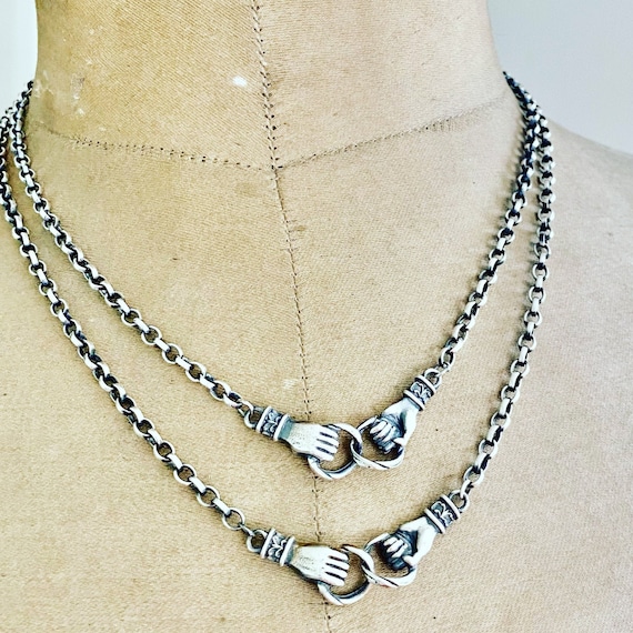 Clasped on sale hands necklace