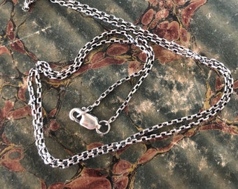 Simple light 1.8mm sterling silver rolo chain.   You choose the length.