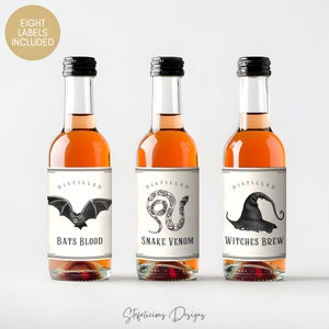 May include: Three small glass bottles with black caps and labels. The labels are white with black text and illustrations of a bat, snake, and witch's hat. The text on the labels reads "Distilled Bats Blood", "Distilled Snake Venom", and "Distilled Witches Brew".