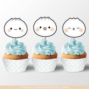 May include: Three blue and white cupcake wrappers with a cute cartoon dumpling design on top. The dumpling has different facial expressions on each cupcake.